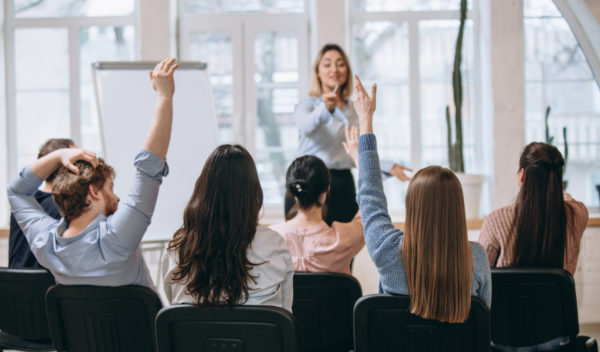 female-speaker-giving-presentation-hall-university-workshop-audience-conference-hall